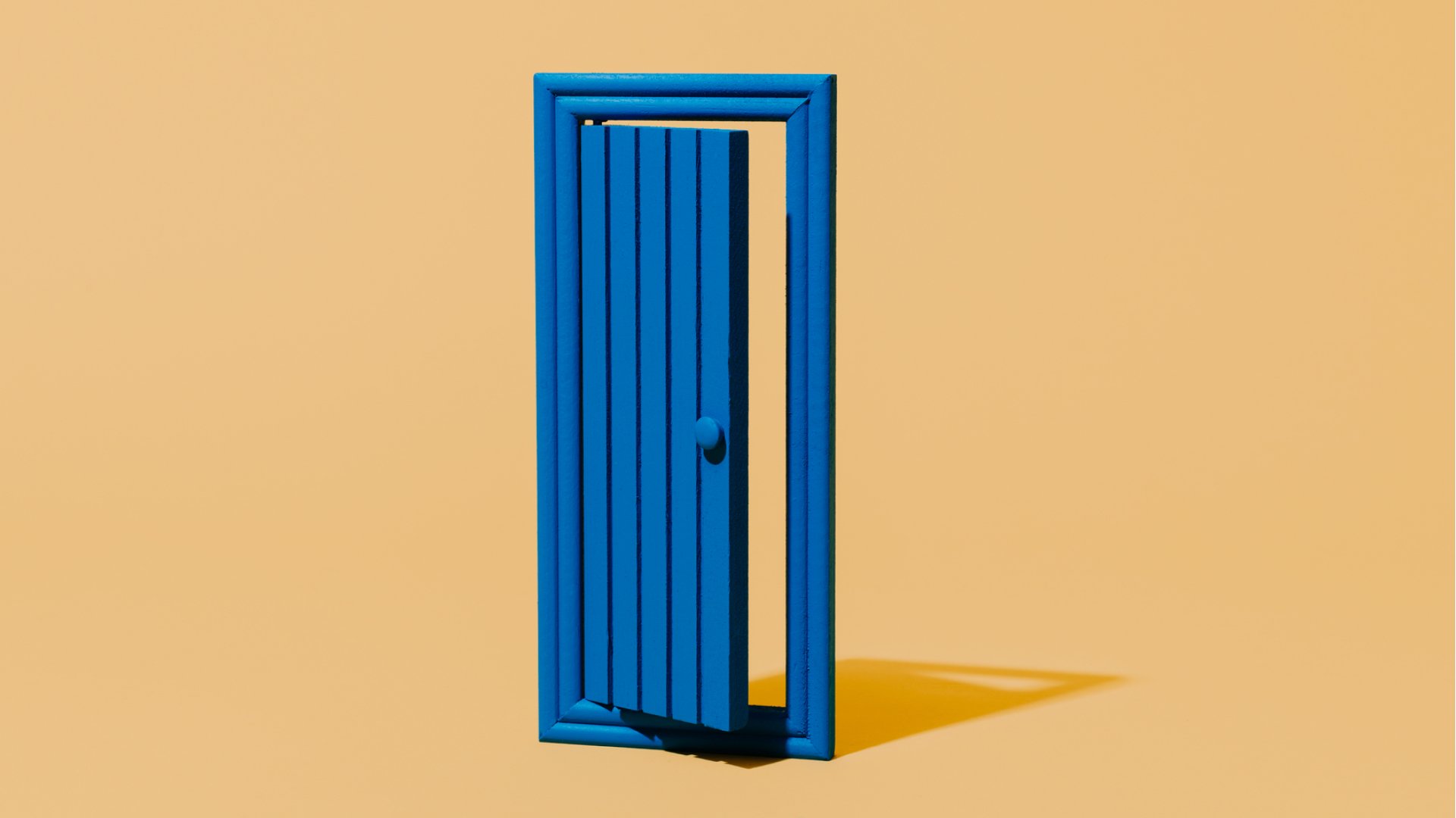 A blue door, standing alone from any wall, against a peachy orange background